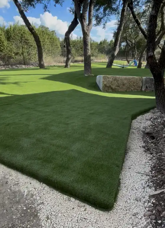 Curved artificial turf lawn edged with gravel
